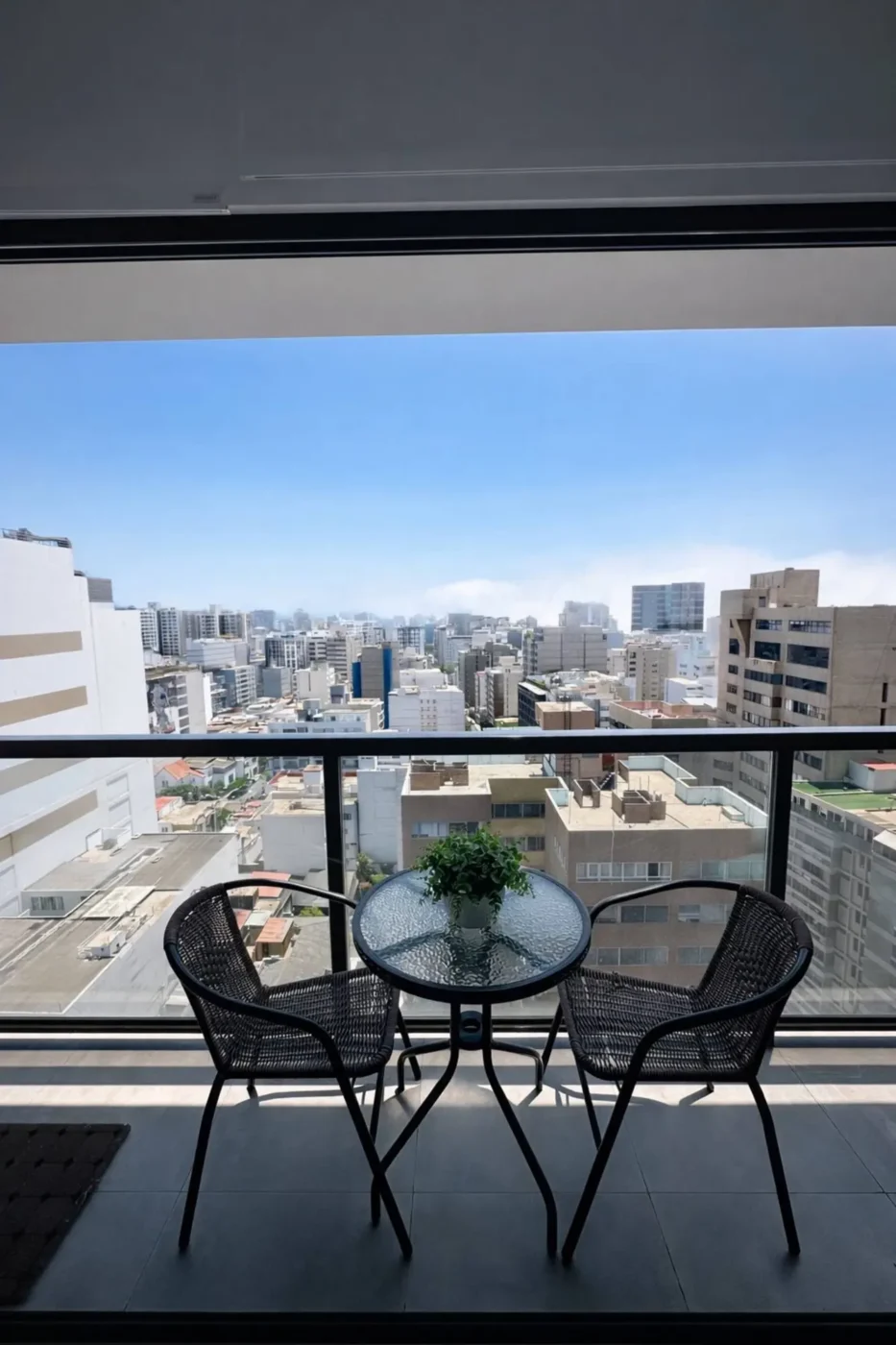 Balcony with bistro table and city view