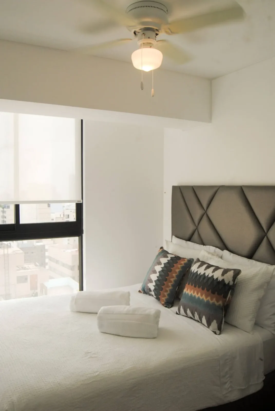 Primary bedroom with upholstered headboard